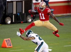 Football player jumping over other player