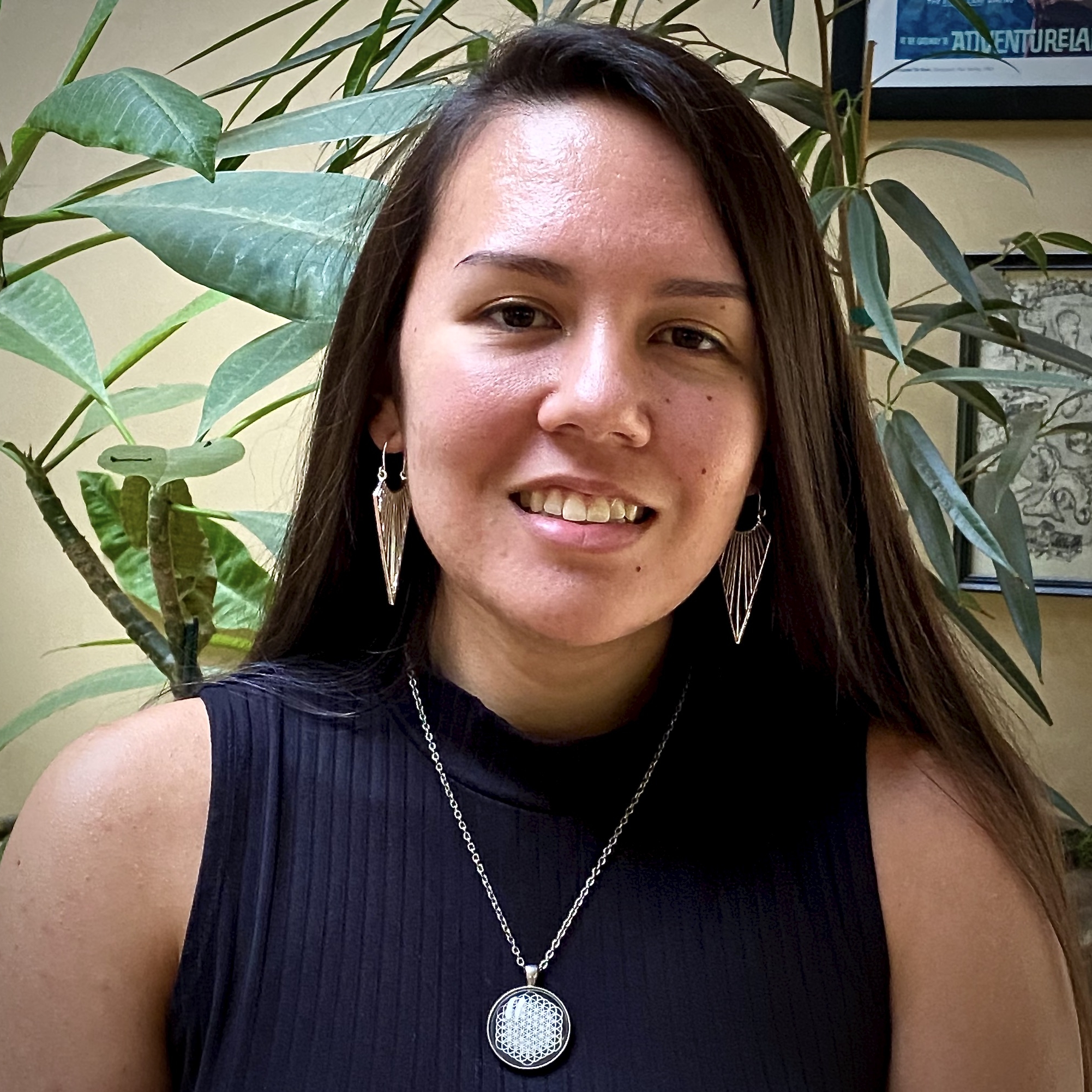 Leonor Bright Photo of Leonor Bright, long straight dark hair, silver dangly earrings and necklace, smiling