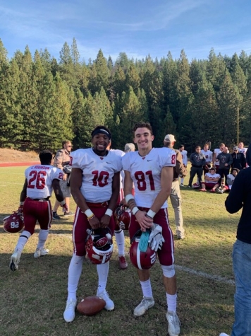 Qntyn Pilcher and Matt Smart standing on football field in gear, smiling