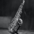 Saxophone in black and white photo on a stand on a stage