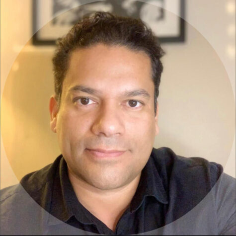 Herman Barahona headshot, smiling with closed mouth, brown eyes and short brown hair