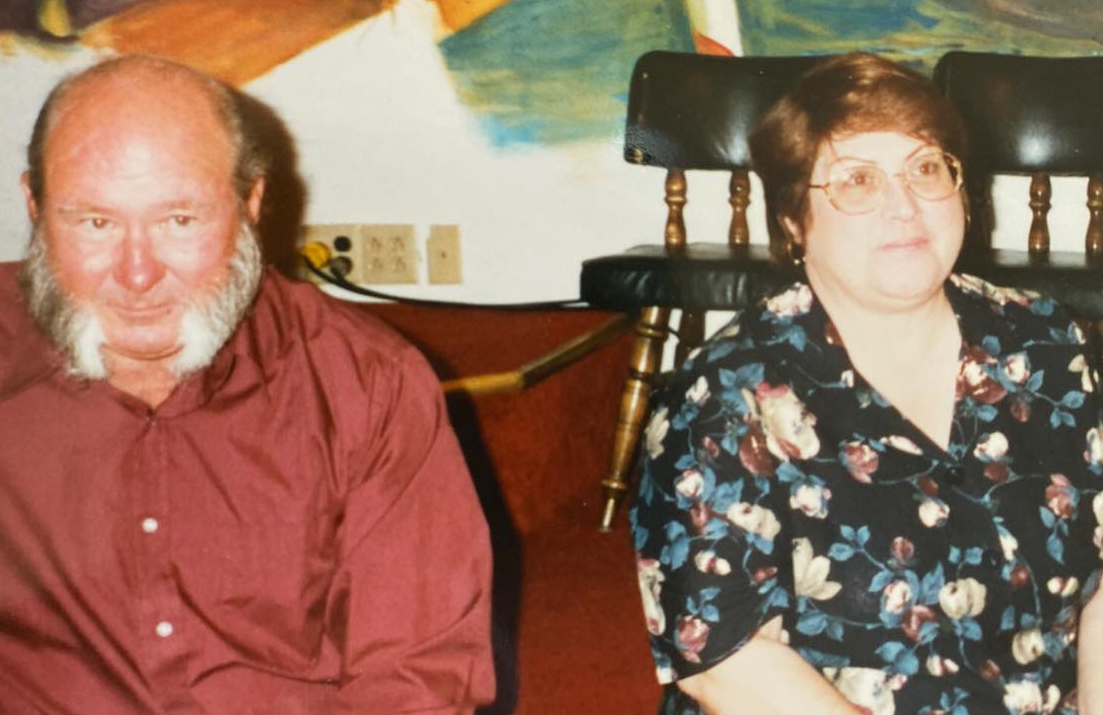 the author's grandpa and grandma who are featured in the story shown sitting on a couch