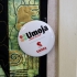 Umoja button pinned to quilt on wall