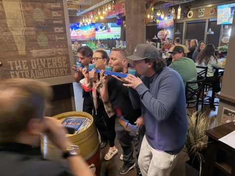 people drinking together in tandem at a restaurant